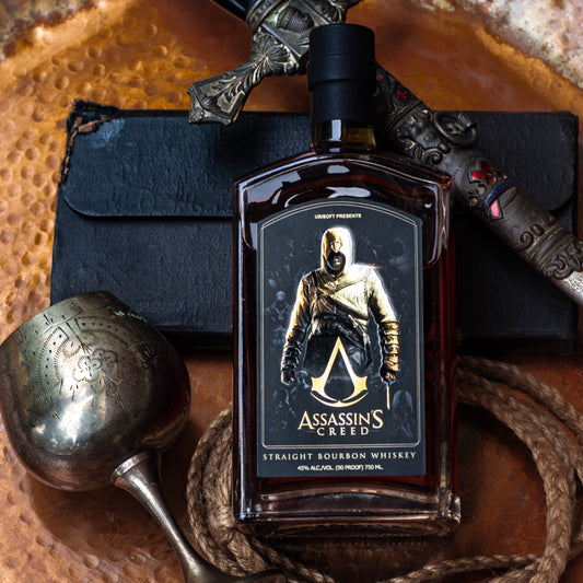 A bottle of Assassin's Creed Straight Bourbon Whiskey with a character from the Assassin's Creed series on the label, surrounded by whiskey-making equipment and a leather belt.